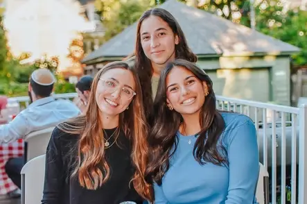 Three smiling young women outdoors
