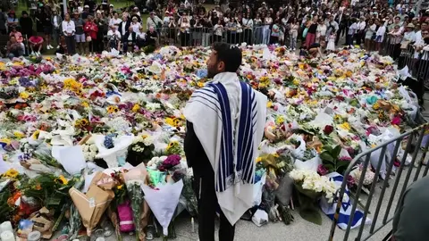 Rabbi giving speech in front of memorial