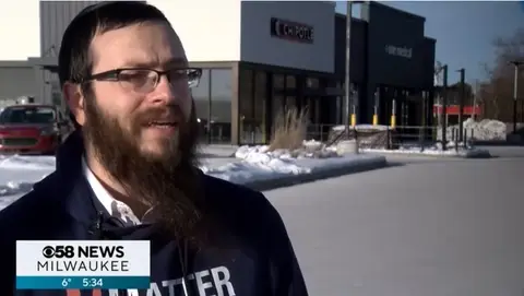 Rabbi being interviewed by cbs outside
