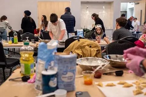 Kids and community members gathering to bake hamantaschen