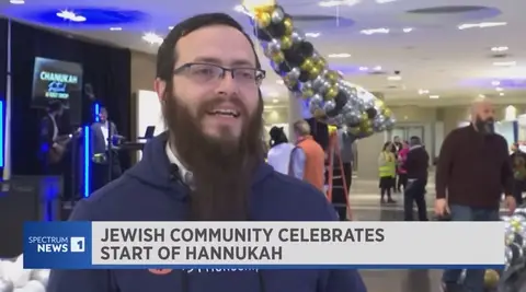 Rabbi being interviewed about Chanukah Festival