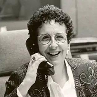 Smiling woman wearing glasses on phone