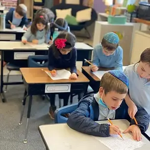Second grade kids learning in classroom
