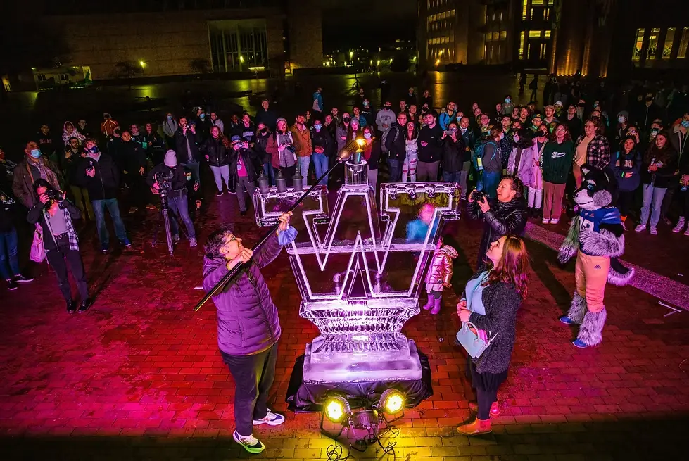 President Cauce lights the lead candle of the Chabad UW Menorah on Red Square.