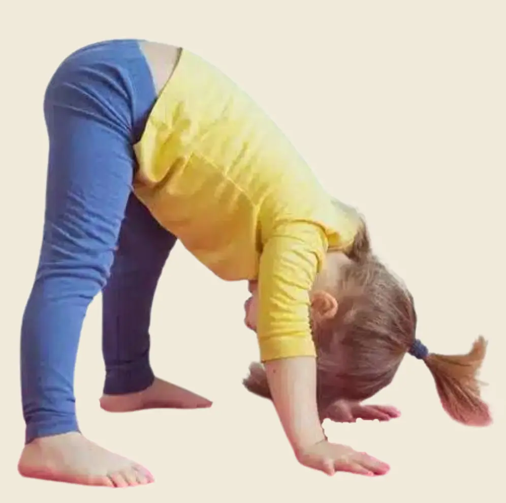 A young girl with a ponytail practicing a yoga pose called dolphin pose, on her hands and feet with hips raised.