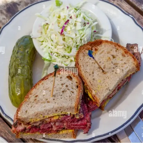 Classic Pastrami Sandwich – $18 Served with: • Sour Pickle • Coleslaw