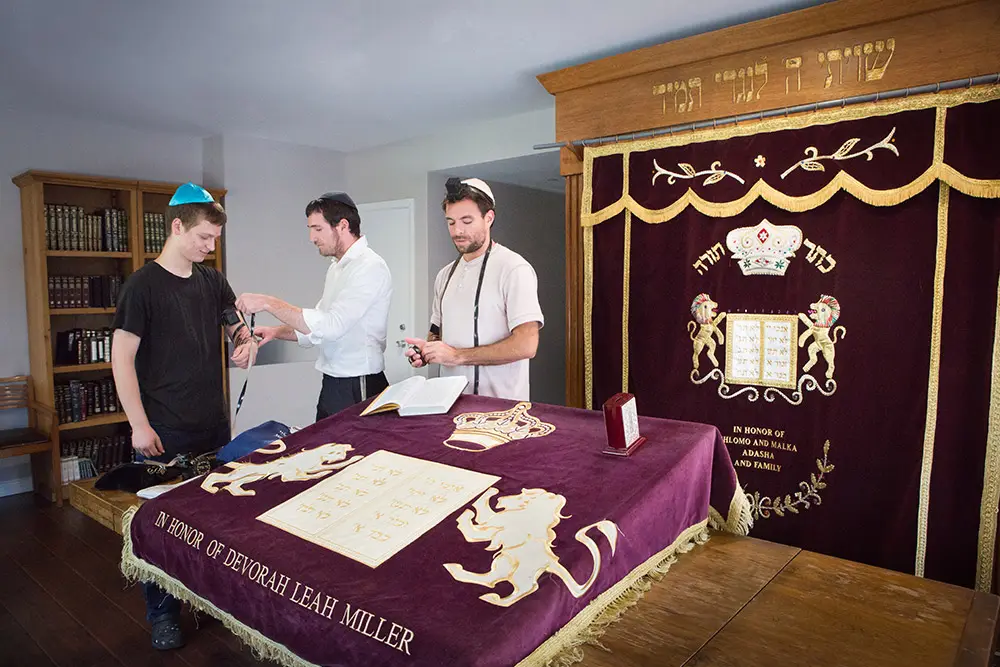 Jewish men preparing for prayer